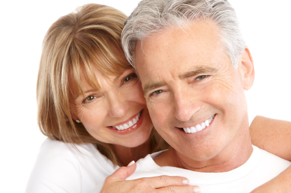 Mature couple smiling with arms holding each other